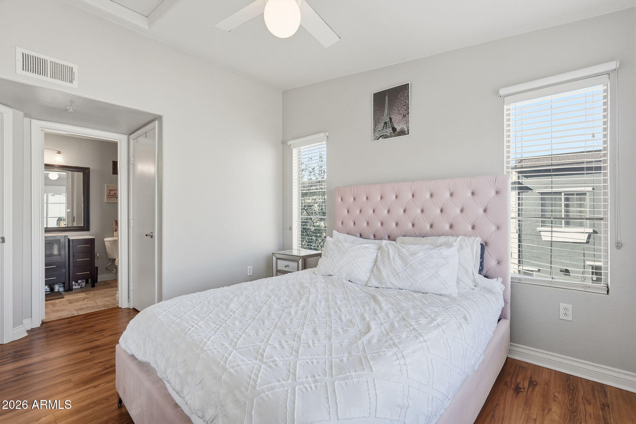 2402 East 5th Street, Unit 1409 Tempe, AZ 85288 - Photo 15 of 34 a bedroom with bed and wooden floor
