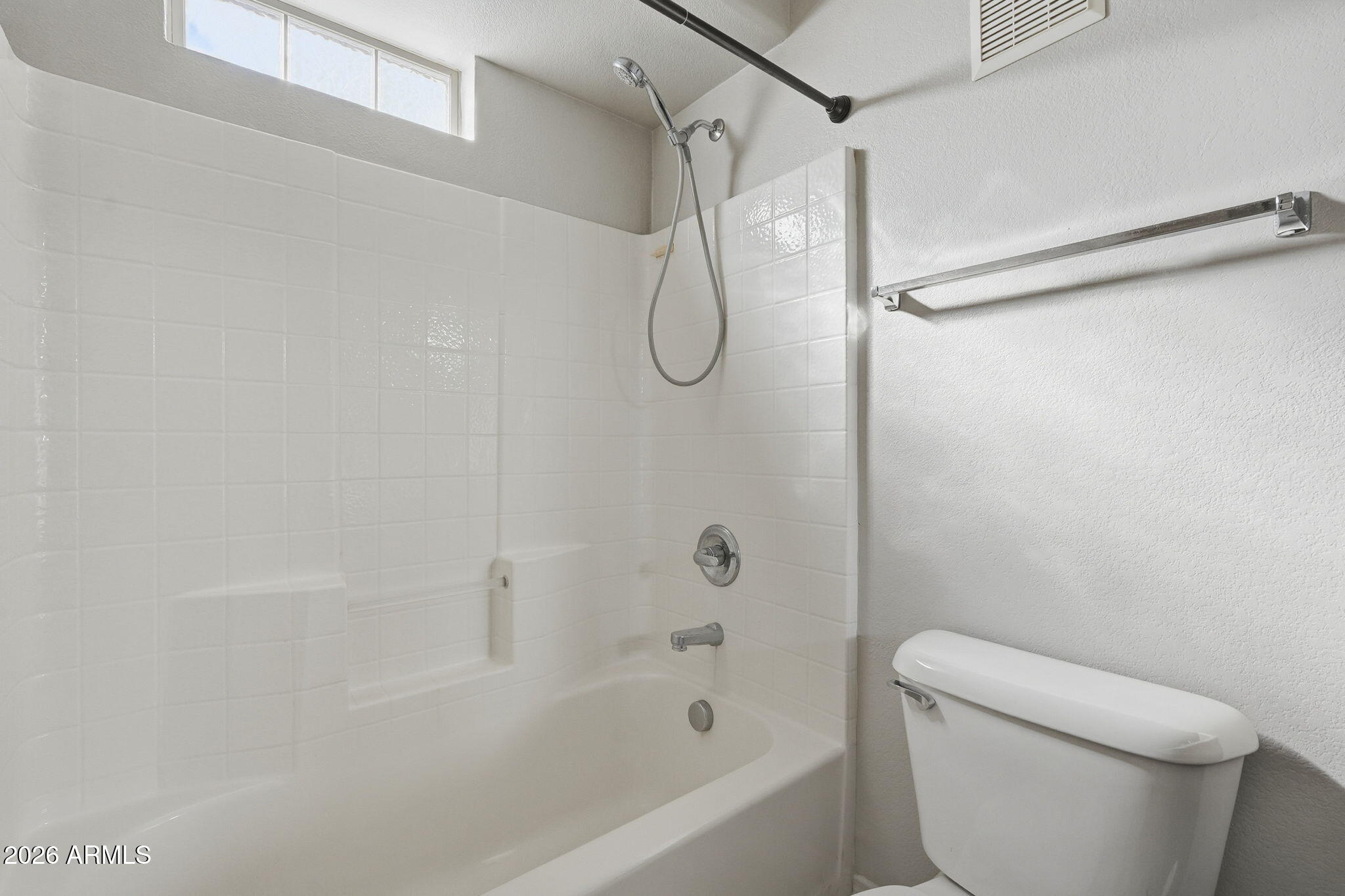 2402 East 5th Street, Unit 1409 Tempe, AZ 85288 - Photo 20 of 34 a bathroom with a shower a toilet and a shower