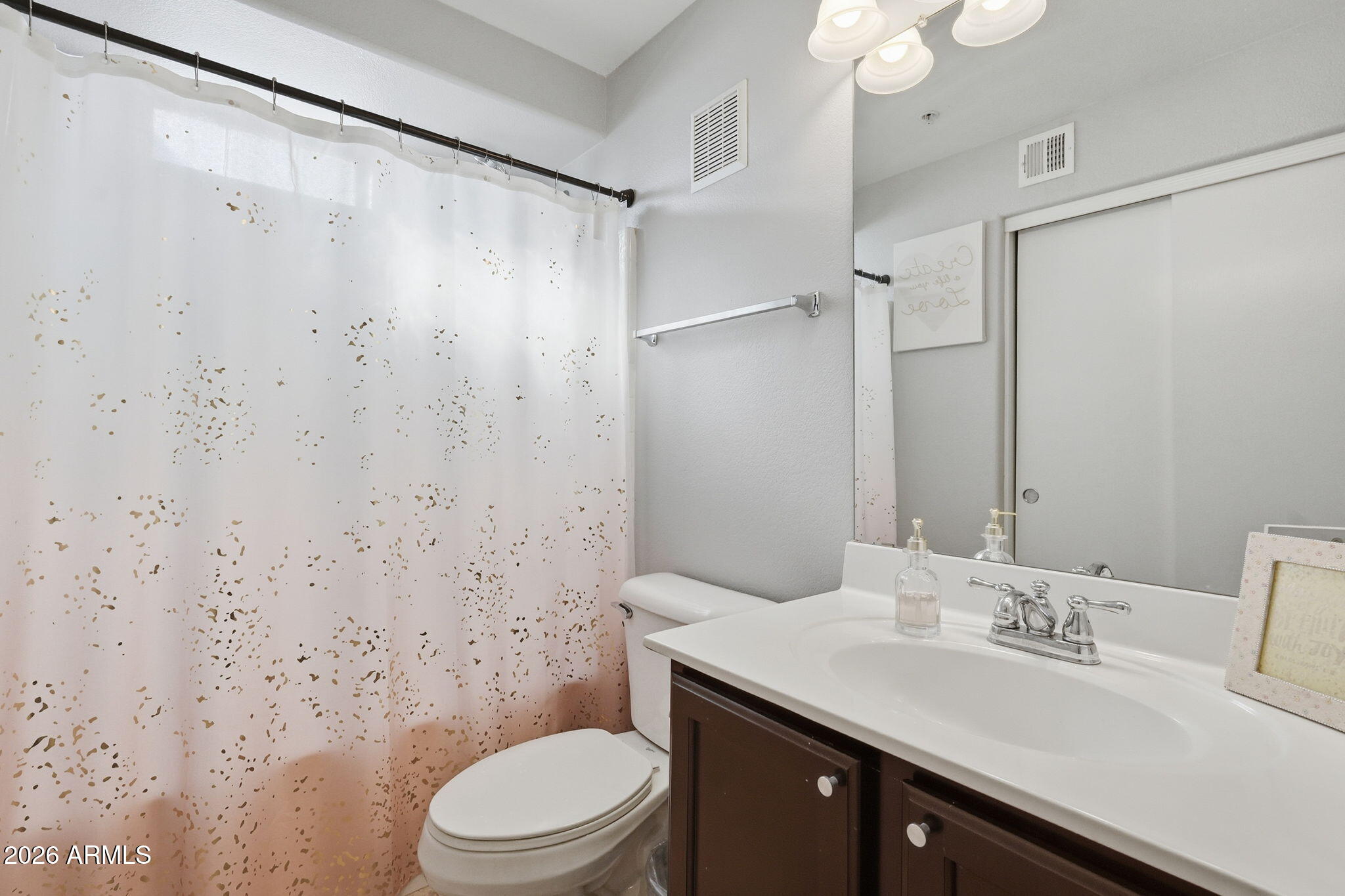 2402 East 5th Street, Unit 1409 Tempe, AZ 85288 - Photo 21 of 34 a bathroom with a toilet a sink and a mirror