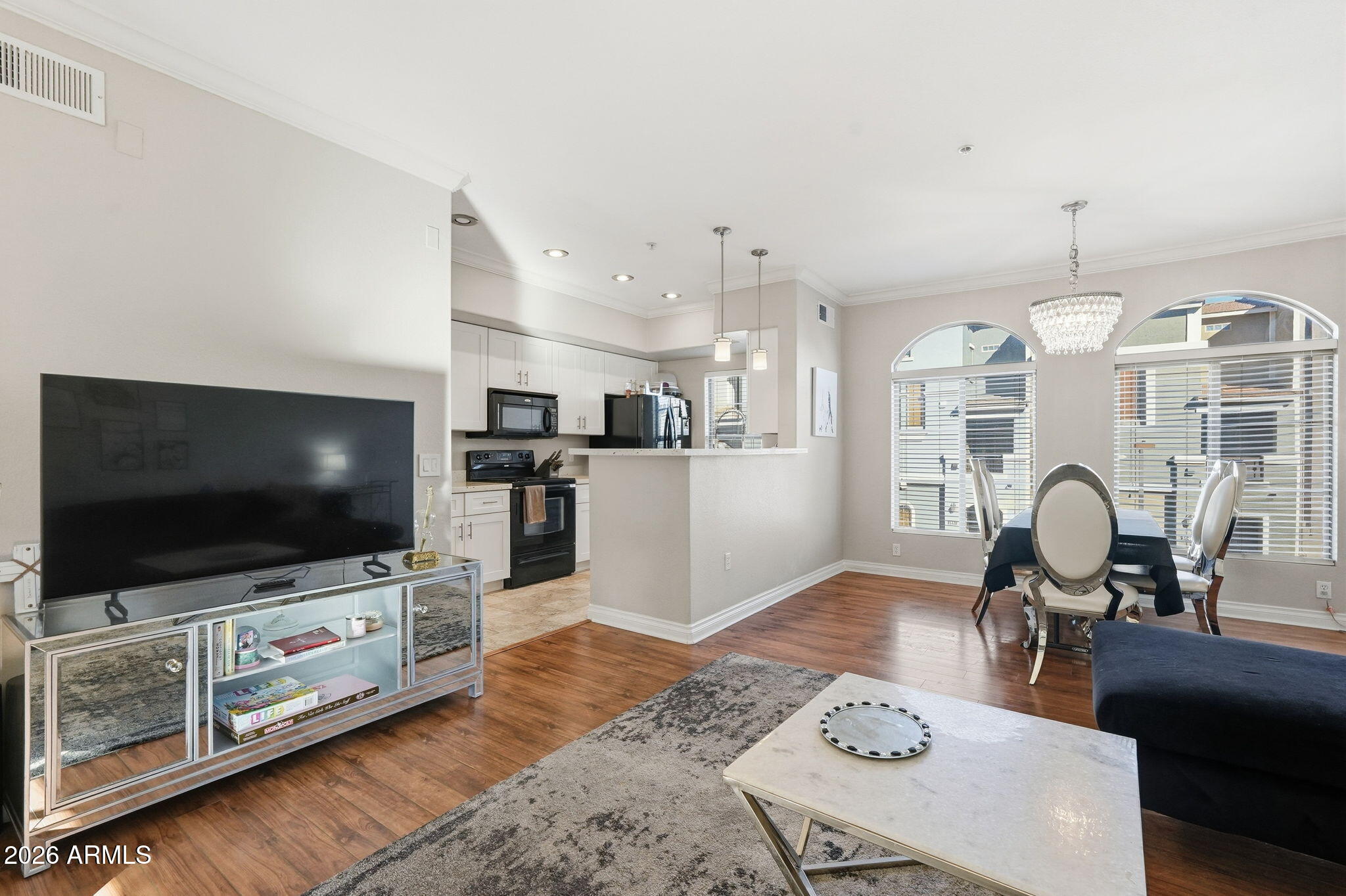 2402 East 5th Street, Unit 1409 Tempe, AZ 85288 - Photo 3 of 34 a living room with furniture and a flat screen tv