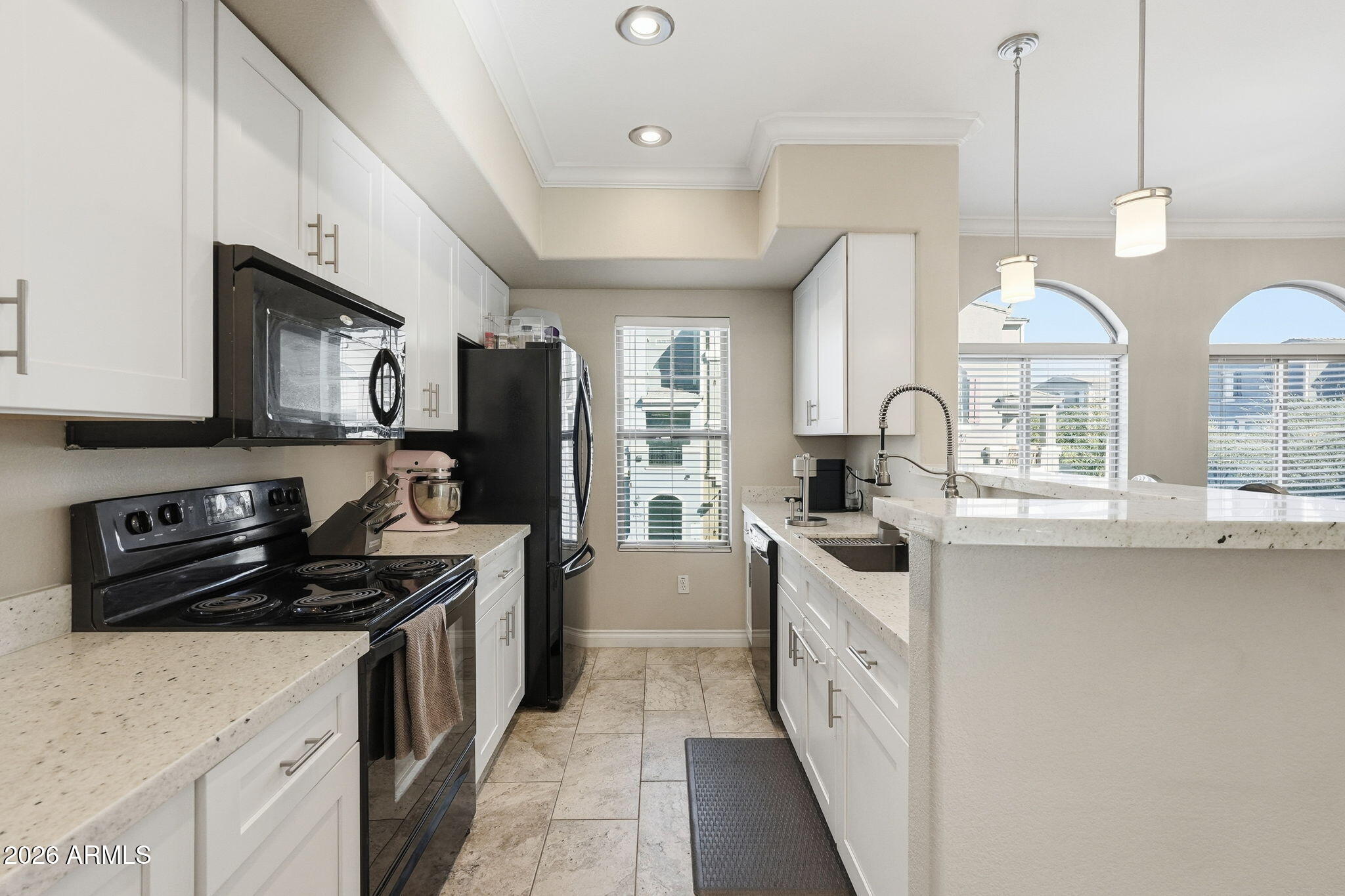 2402 East 5th Street, Unit 1409 Tempe, AZ 85288 - Photo 6 of 34 a kitchen with stainless steel appliances a sink stove and refrigerator
