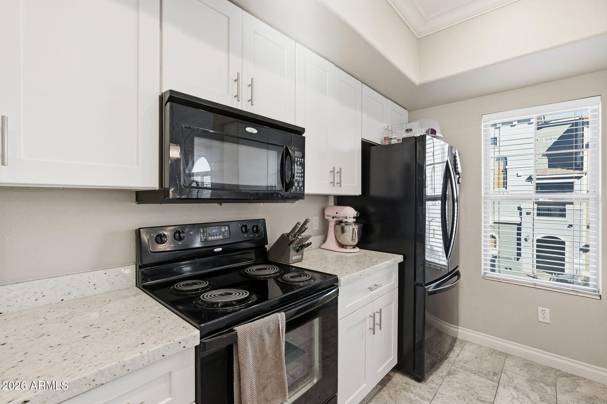 2402 East 5th Street, Unit 1409 Tempe, AZ 85288 - Photo 7 of 34 a kitchen with stainless steel appliances a stove a microwave a sink and cabinets