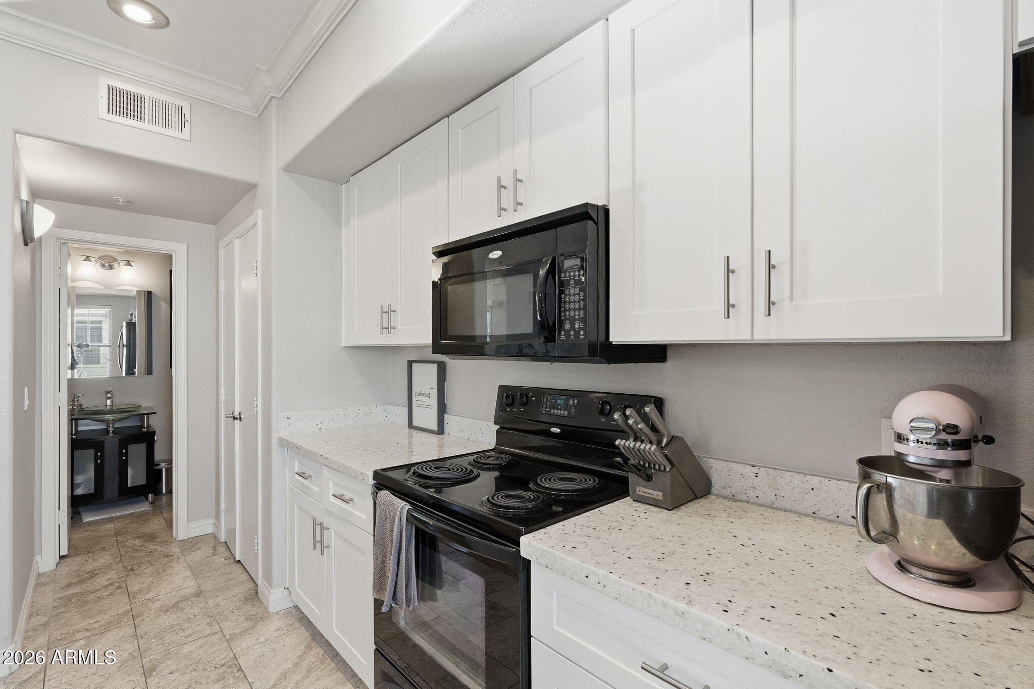 2402 East 5th Street, Unit 1409 Tempe, AZ 85288 - Photo 10 of 34 a kitchen with a stove and a microwave