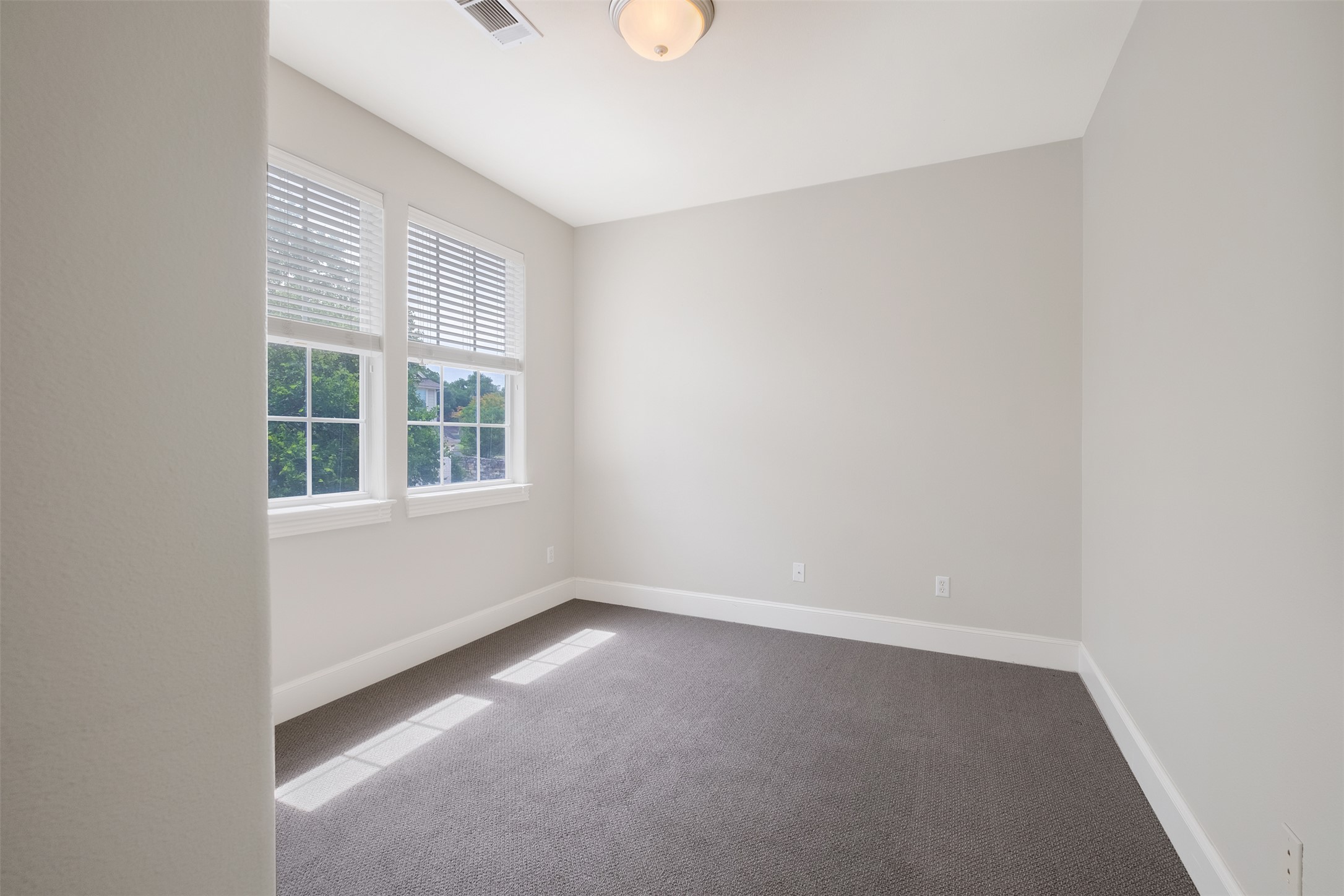 6715 Windrift Way, Unit 8 Austin, TX 78745 - Photo 21 of 24 Sun-filled interior space with ample natural light from multiple windows.