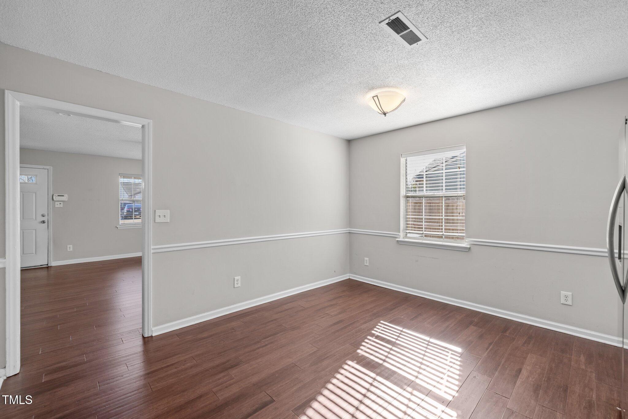 4104 Ludgate Drive Durham, NC 27713 - Photo 14 of 46 wooden floor in an empty room with a window