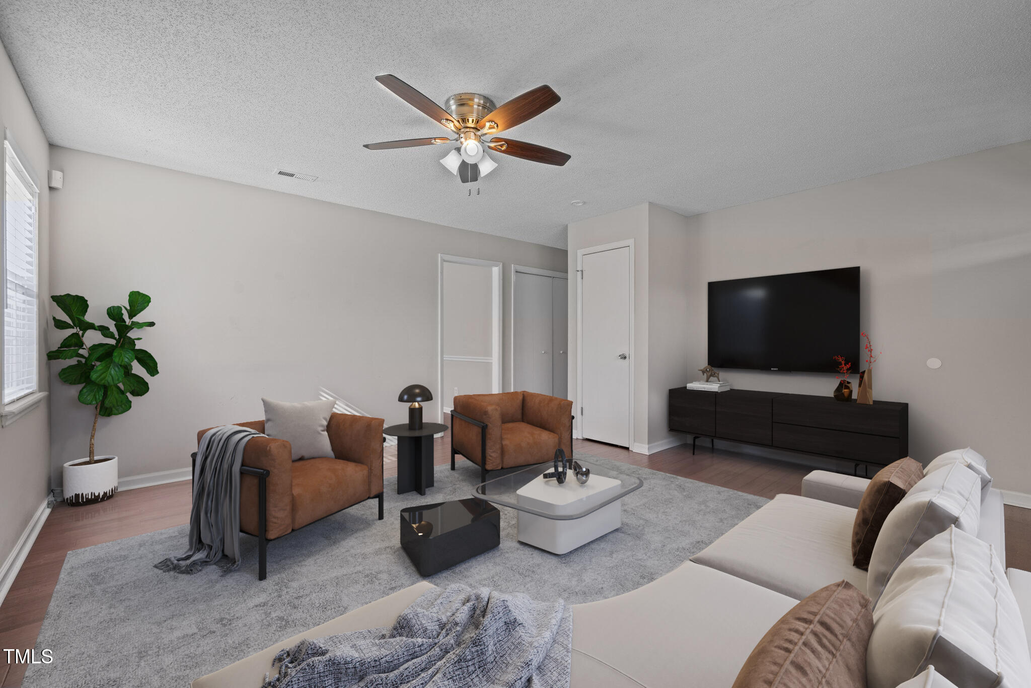 4104 Ludgate Drive Durham, NC 27713 - Photo 17 of 46 a living room with furniture and a flat screen tv