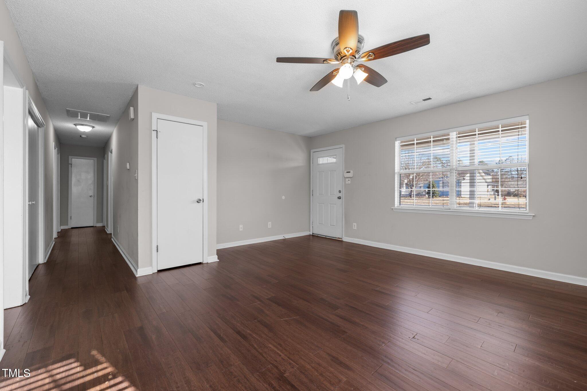 4104 Ludgate Drive Durham, NC 27713 - Photo 20 of 46 a view of an empty room with wooden floor and a window