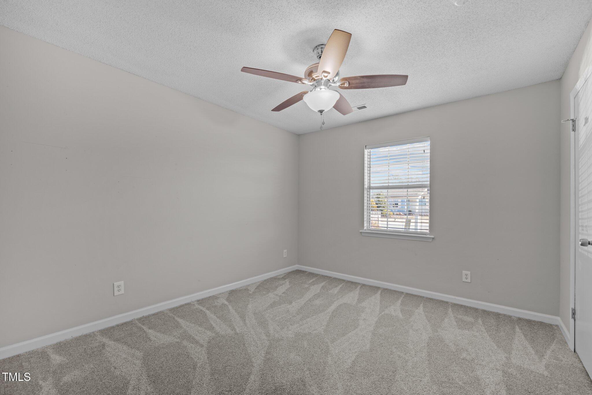 4104 Ludgate Drive Durham, NC 27713 - Photo 22 of 46 an empty room with a window and a fan
