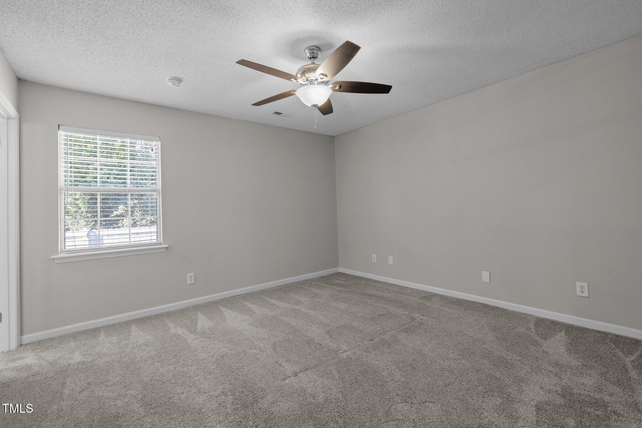 4104 Ludgate Drive Durham, NC 27713 - Photo 24 of 46 an empty room with ceiling fan and window
