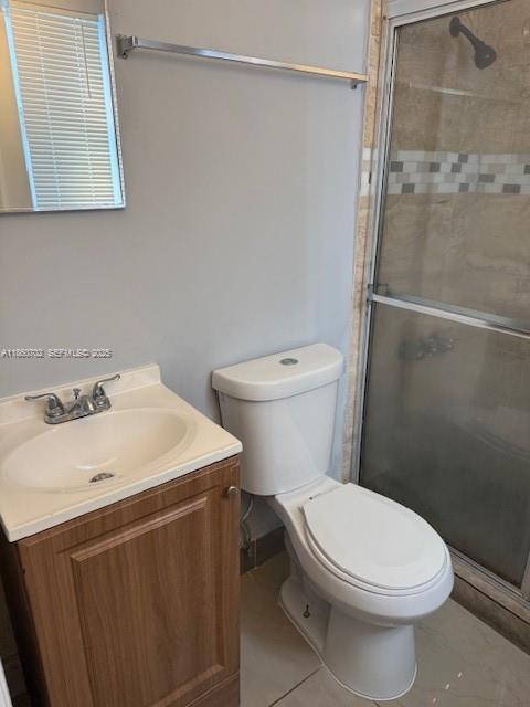 172 Northwest 12th Street, Unit 2 Miami, FL 33136 - Photo 11 of 11 a white toilet sitting next to a bathroom sink