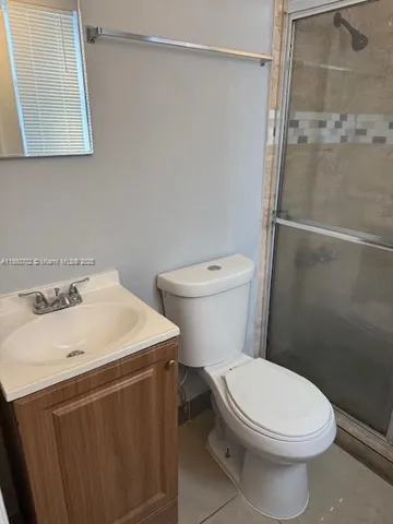 a white toilet sitting next to a bathroom sink