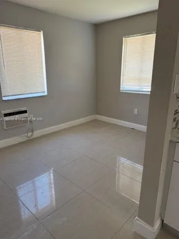 a sink with white cabinets