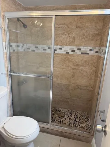 a bathroom with a shower and a toilet