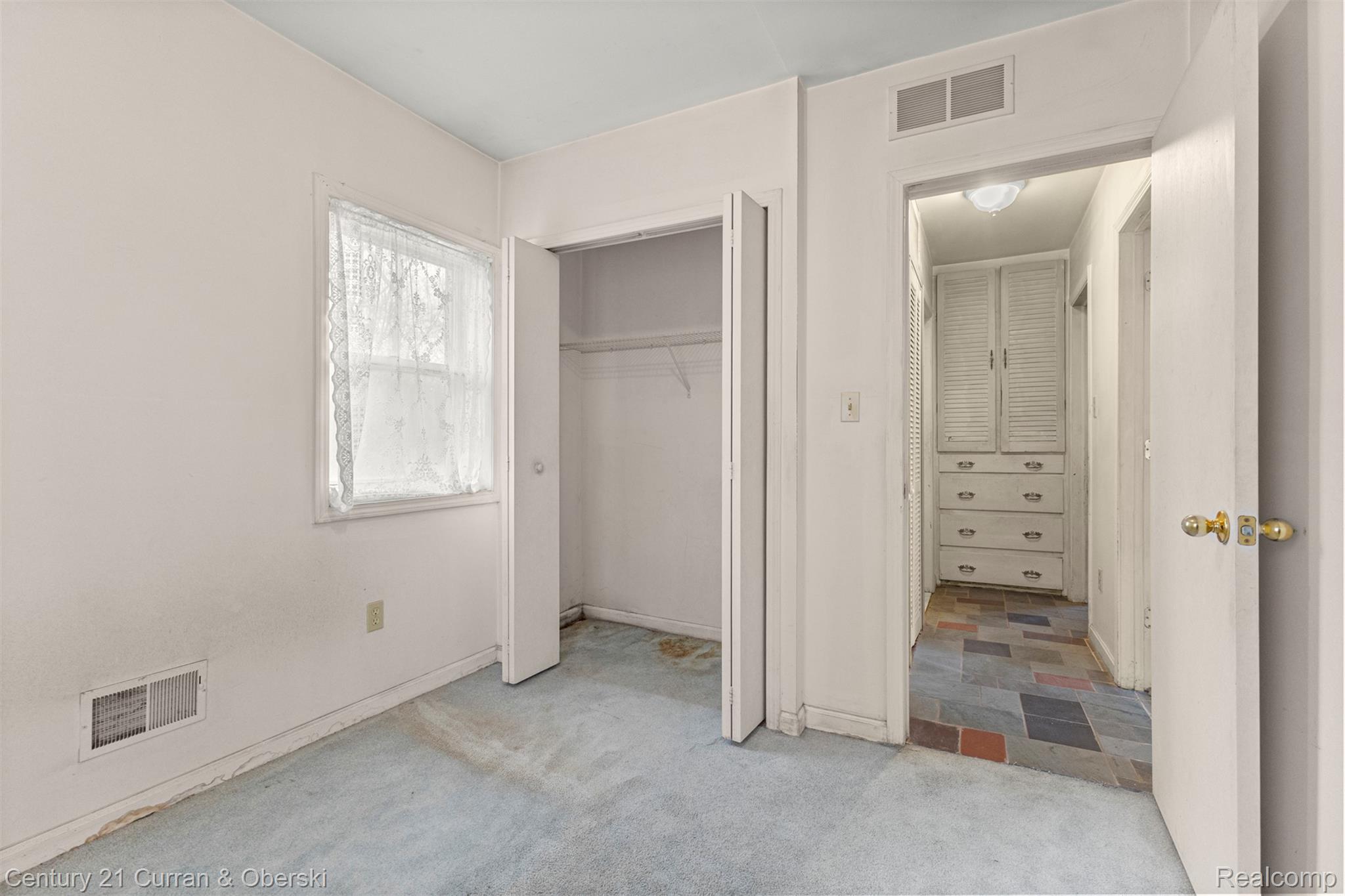25205 Inkster Road Farmington, MI 48336 - Photo 25 of 46 Unfurnished bedroom featuring light carpet and a closet