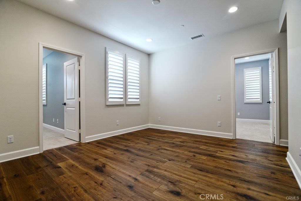 128 Brambles Irvine, CA 92618 - Photo 18 of 27 an empty room with wooden floor and windows