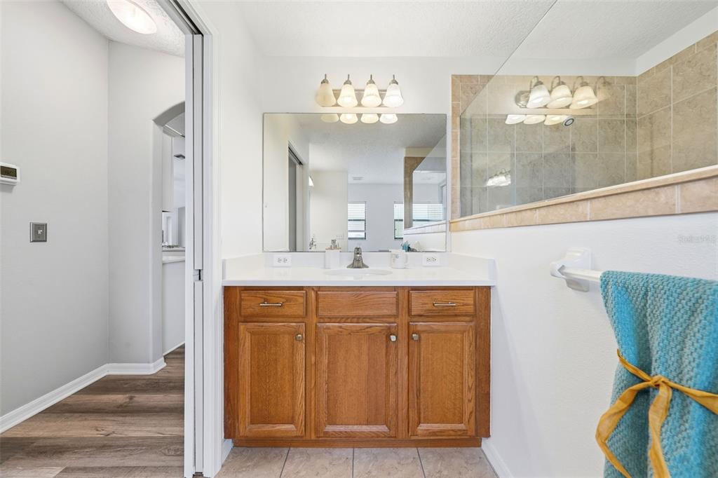 14433 Lake Yale Road Umatilla, FL 32784 - Photo 15 of 38 a bathroom with a sink a light fixture and a mirror