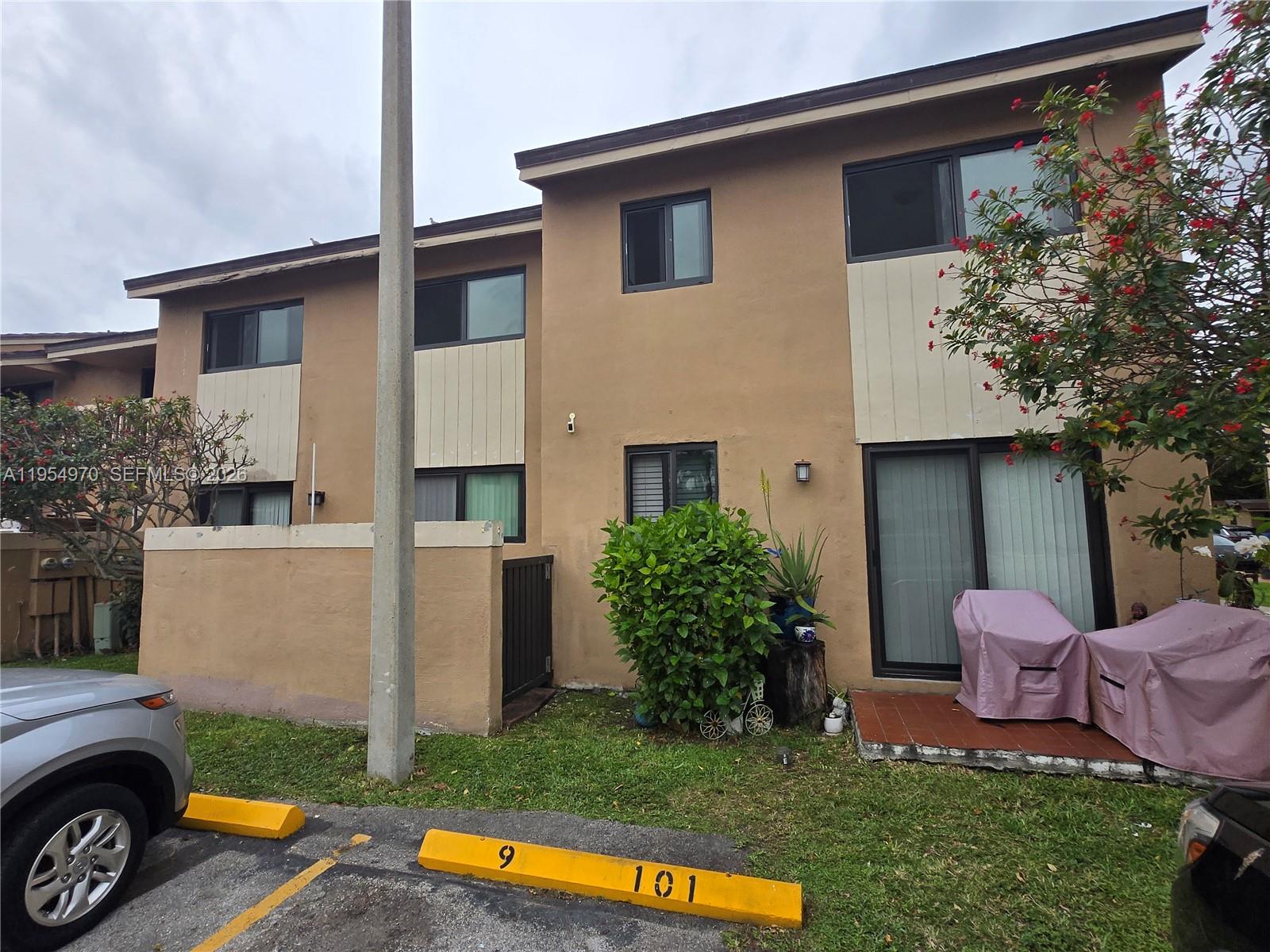 a front view of a house with a yard table and chairs