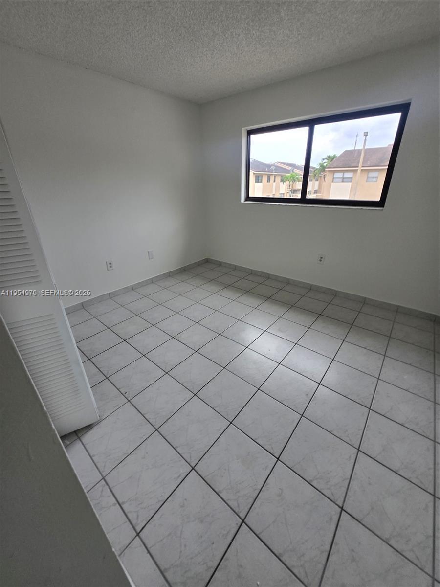 15439 Southwest 80th Street, Unit 2029 Miami, FL 33193 - Photo 12 of 16 an empty room with windows