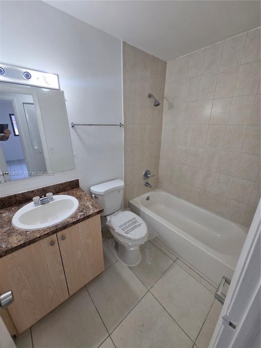 15439 Southwest 80th Street, Unit 2029 Miami, FL 33193 - Photo 13 of 16 a bathroom with a sink toilet and shower