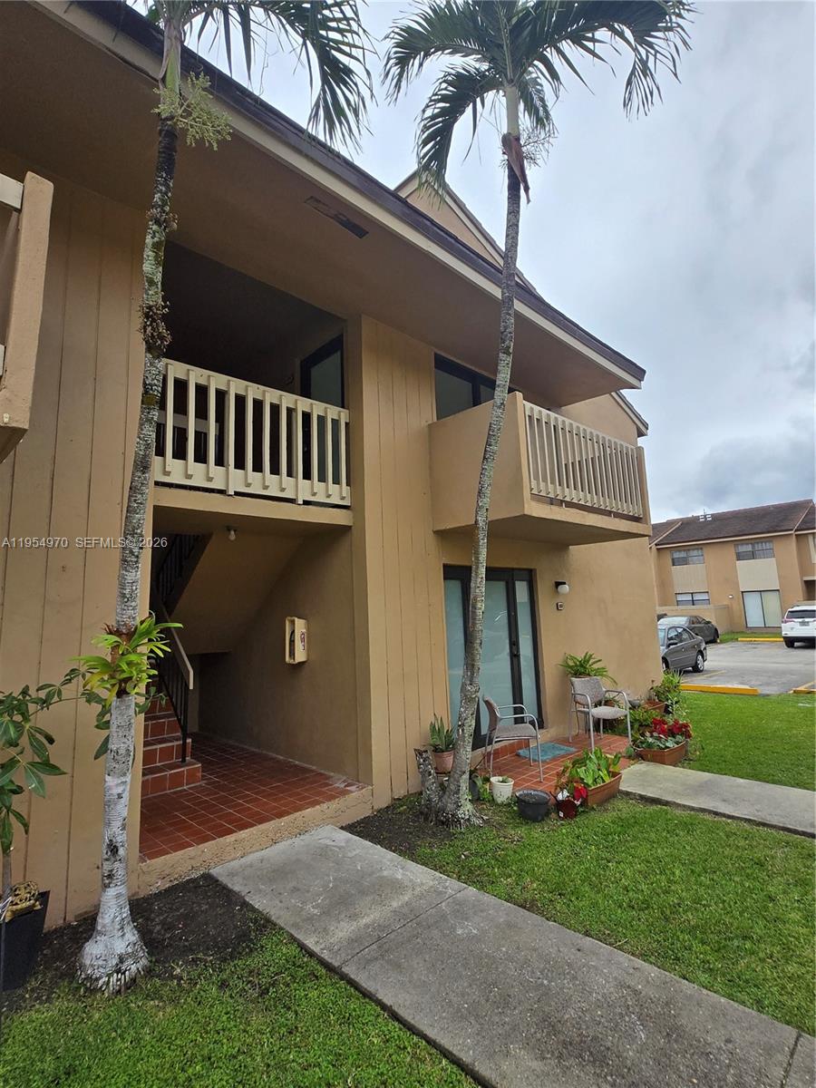 15439 Southwest 80th Street, Unit 2029 Miami, FL 33193 - Photo 3 of 16 a view of a house with a yard and sitting area