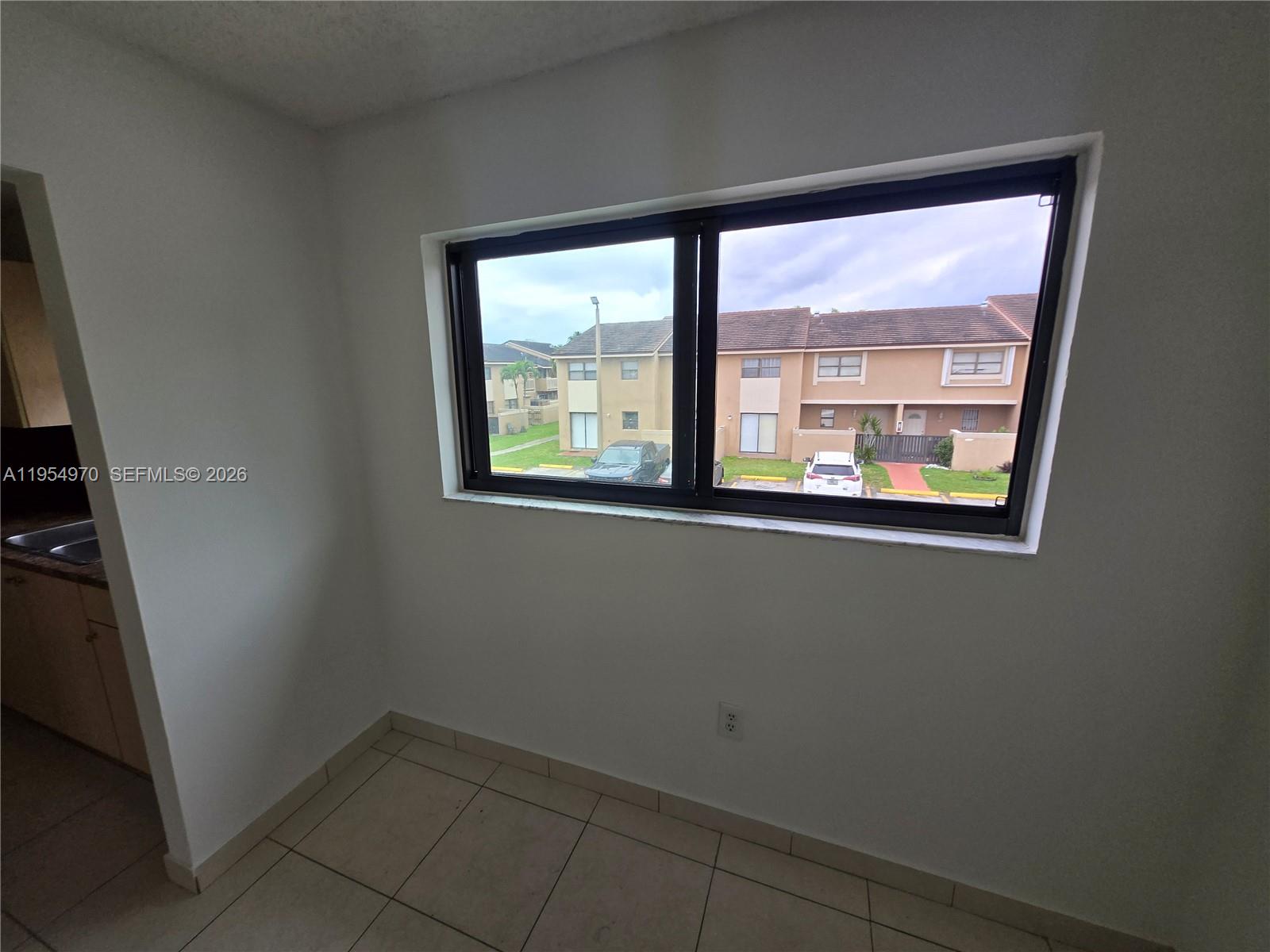 15439 Southwest 80th Street, Unit 2029 Miami, FL 33193 - Photo 5 of 16 a view of an empty room with a window