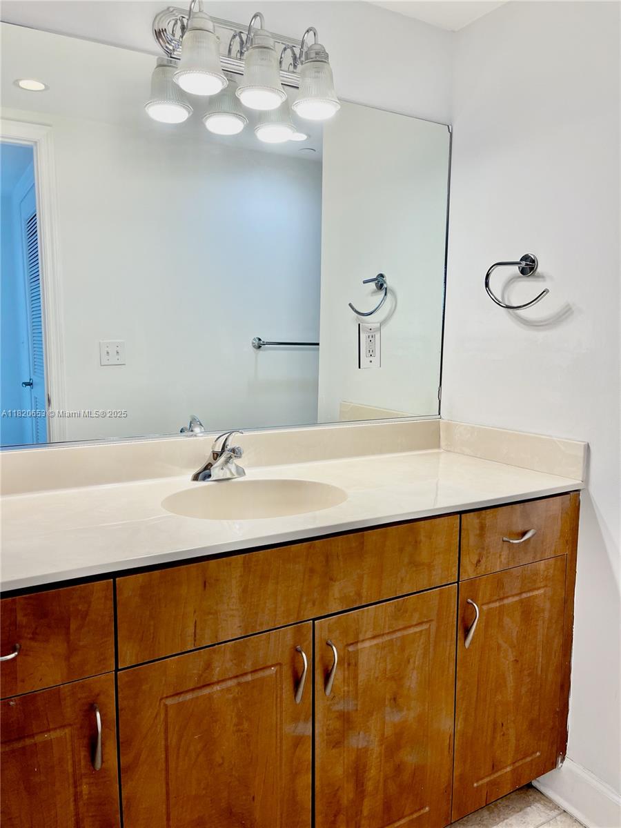 401 69th Street, Unit 405 Miami Beach, FL 33141 - Photo 12 of 25 a bathroom with a sink and a mirror