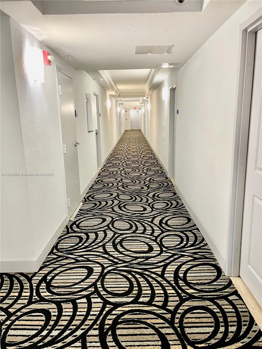 401 69th Street, Unit 405 Miami Beach, FL 33141 - Photo 16 of 25 a view of a hallway