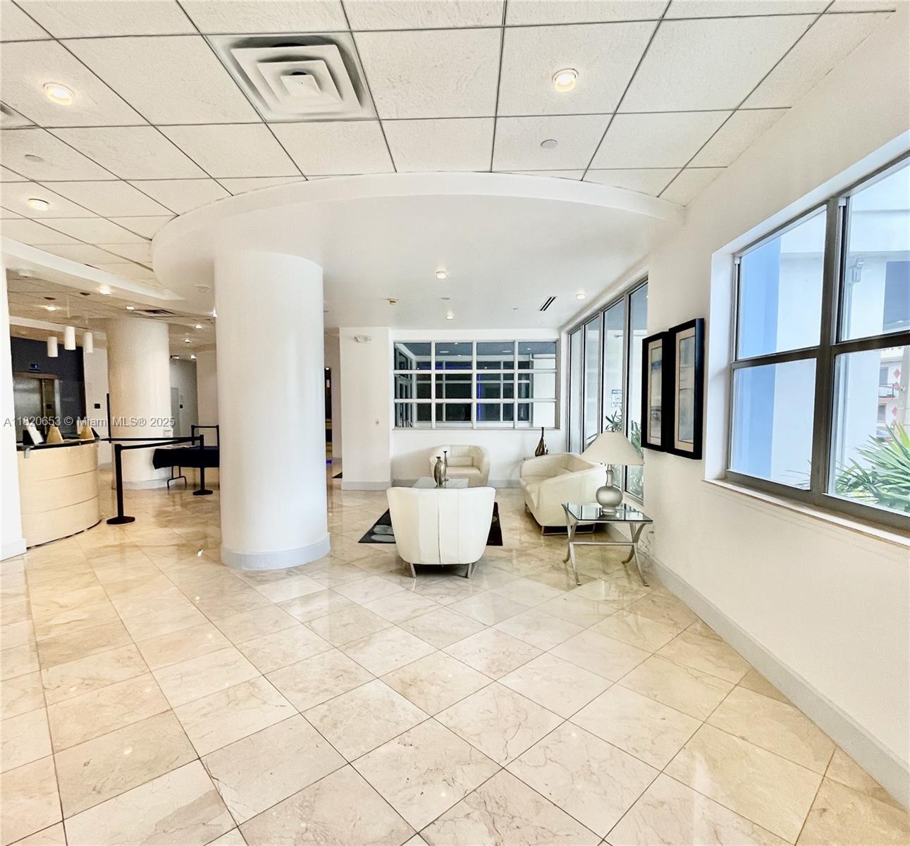 401 69th Street, Unit 405 Miami Beach, FL 33141 - Photo 23 of 25 a lobby with furniture and a rug