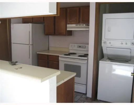 a kitchen with a sink a stove and refrigerator