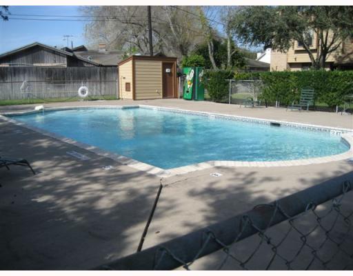 7130 Everhart Road, Unit 35 Corpus Christi, TX 78413 - Photo 7 of 8 a front view of a house with a yard and garage