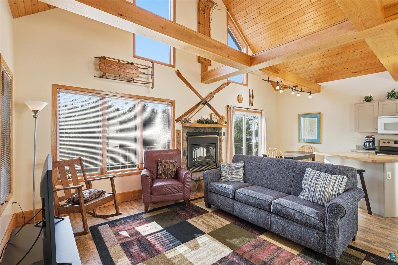 6266 Giants Ridge Road Biwabik, MN 55705 - Photo 18 of 29 Vaulted wood plank ceilings with exposed beams define this living area