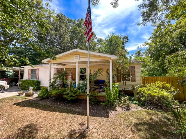a view of a house with yard and a garden