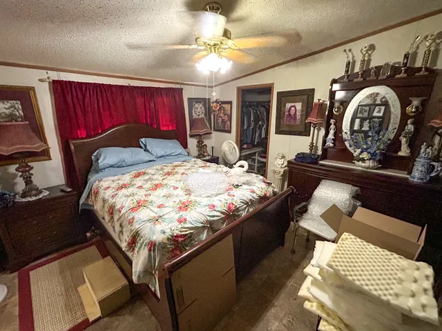 a bed sitting in a bedroom next to a window