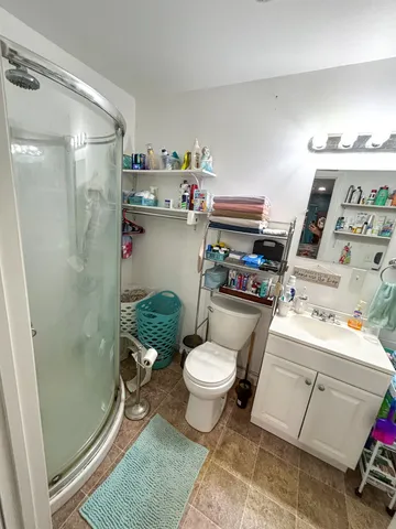 a kitchen with stainless steel appliances granite countertop a sink dishwasher and a refrigerator with wooden floor