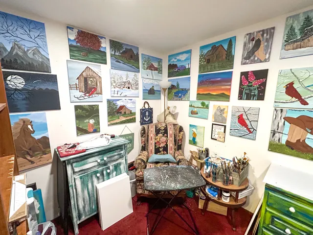 a room with lots of white furniture and wooden floor