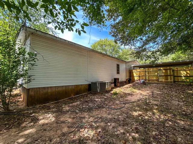 a view of a yard with wooden fence