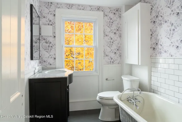 a bathroom with a sink a toilet and shower curtain