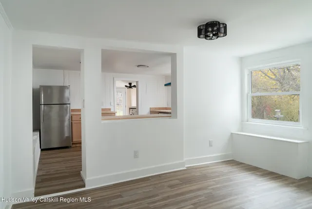 a view of kitchen with furniture and wooden floor