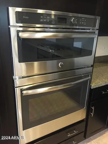 a stove top oven sitting inside of a kitchen