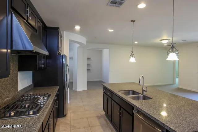 a kitchen with a sink a stove and a refrigerator