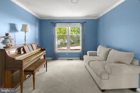 an empty room with windows and cabinet