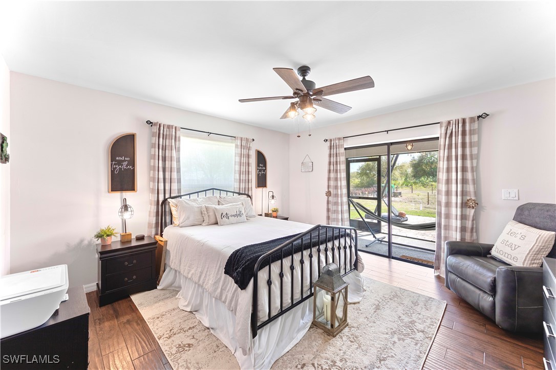 7583 18th Place LaBelle, FL 33935 - Photo 15 of 36 a bedroom with a large bed couch and a window