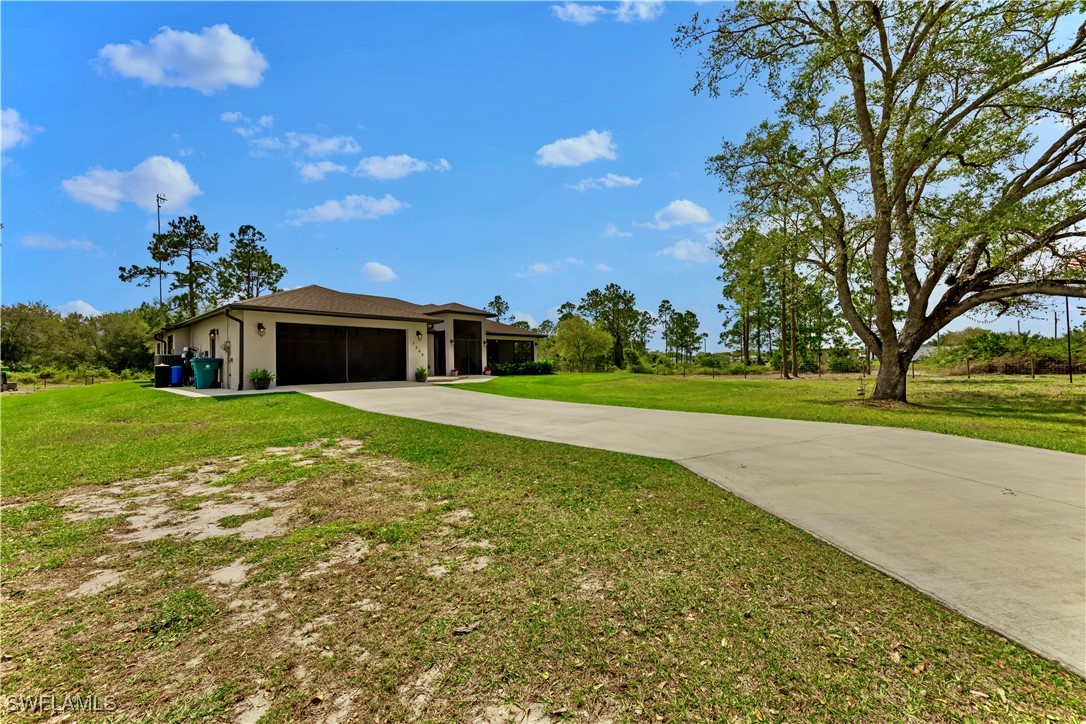 7583 18th Place LaBelle, FL 33935 - Photo 2 of 36 a view of a house with a yard