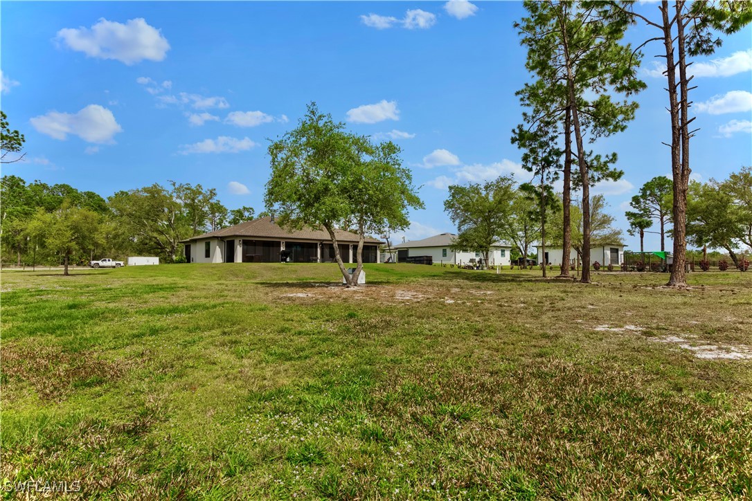 7583 18th Place LaBelle, FL 33935 - Photo 30 of 36 a front view of a house with a yard