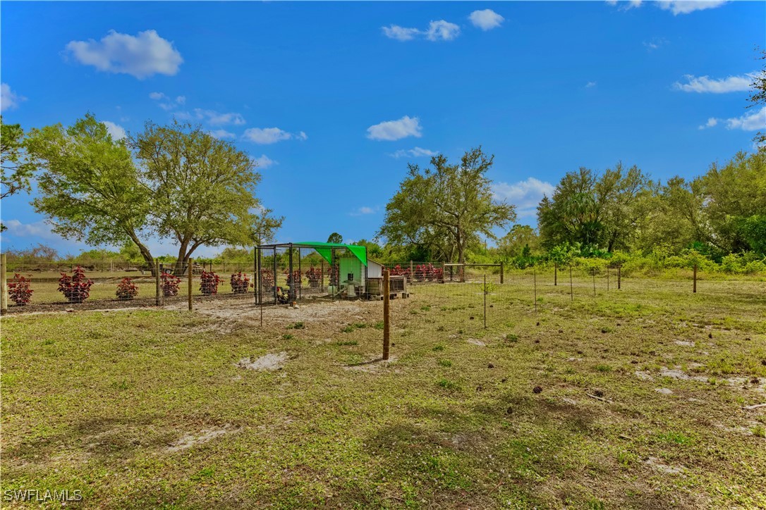 7583 18th Place LaBelle, FL 33935 - Photo 31 of 36 a view of swimming pool with outdoor seating and trees