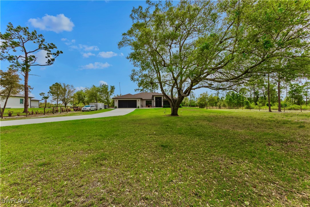 7583 18th Place LaBelle, FL 33935 - Photo 4 of 36 a view of green field with tree in the background