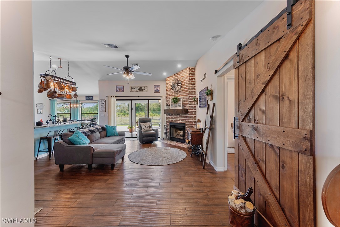 7583 18th Place LaBelle, FL 33935 - Photo 9 of 36 a living room with furniture or chandelier and a wooden floor