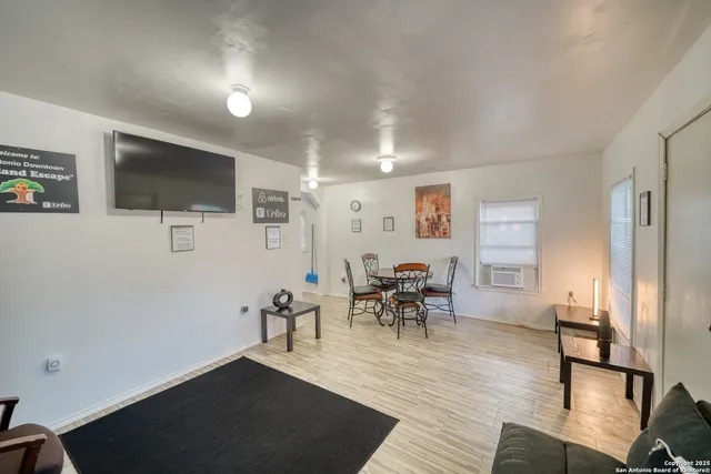 a view of a livingroom with furniture and a flat screen tv