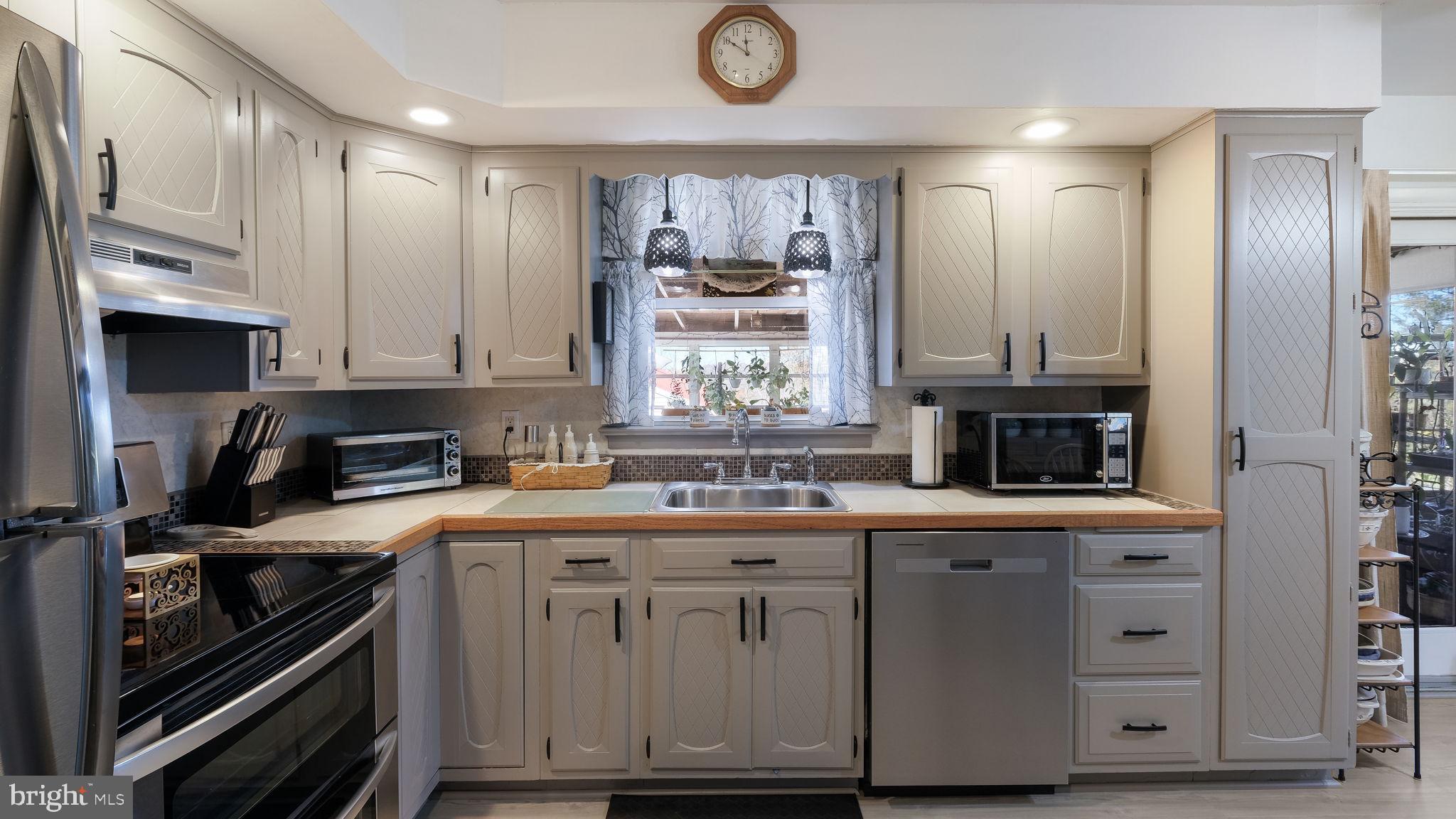 7078 Easton Road Pipersville, PA 18947 - Photo 11 of 45 a kitchen with a stove and a refrigerator