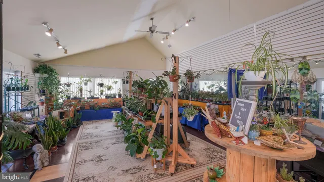 a kitchen with stainless steel appliances kitchen island granite countertop a table and chairs in it